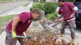 Inmates shoveling dirt to fill hole