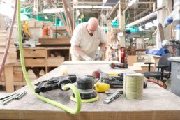 inmate working at furniture shop with several hand tools