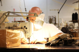 Inmate sewing textiles with sewing machine