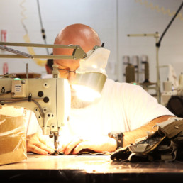 Inmate sewing textiles with sewing machine