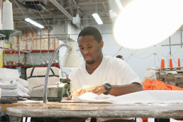 Inmate sewing textiles with sewing machine