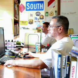 Inmates working on computers to design signs at the sign shop in Gunnison Utah