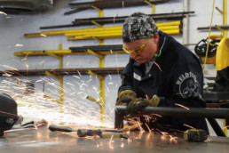 Inmate grinding a piece of metal